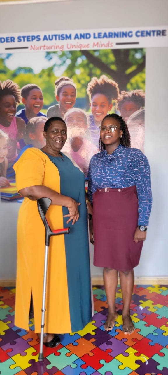 Minister Hon. Asamo Hellen Grace with a Tender Steps staff member