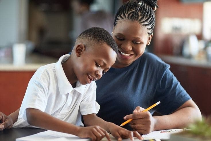 A parent supporting her son during a learning session at Tender Steps